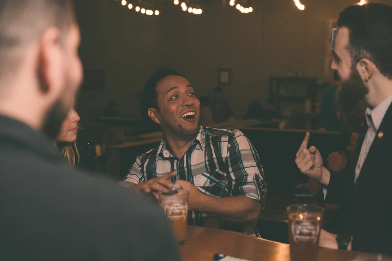 Guests reacting to close-up magic around a table