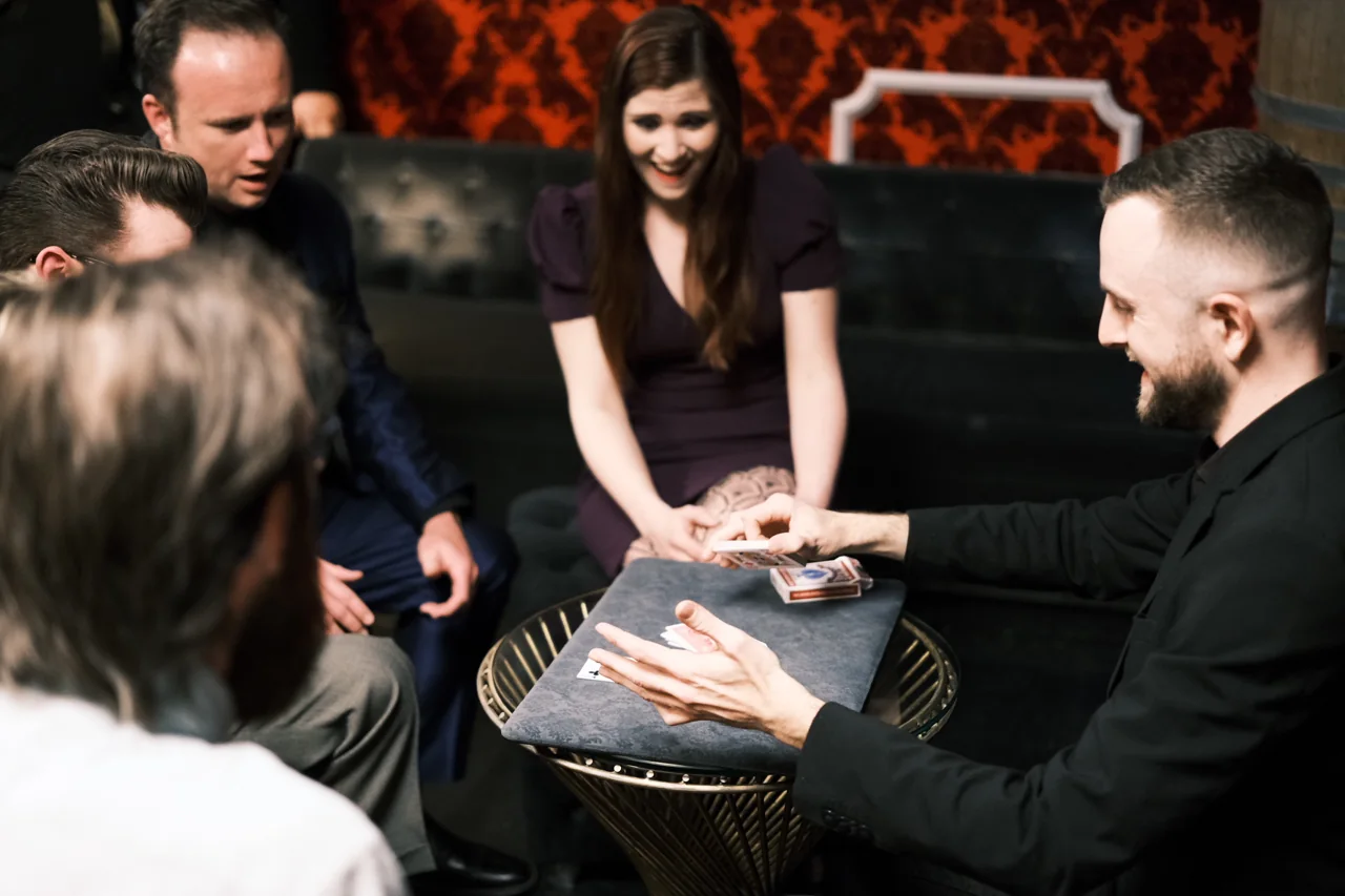A seated audience watching Frankie Foti perform close-up card magic in Las Vegas