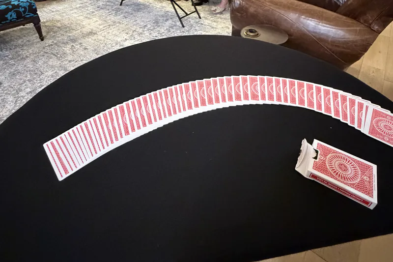 A deck of cards spread across Frankie Foti&rsquo;s close-up magic pad at a house party